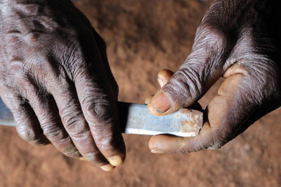 Knife used for girls' genital cutting in the hands of an old circumciser woman.